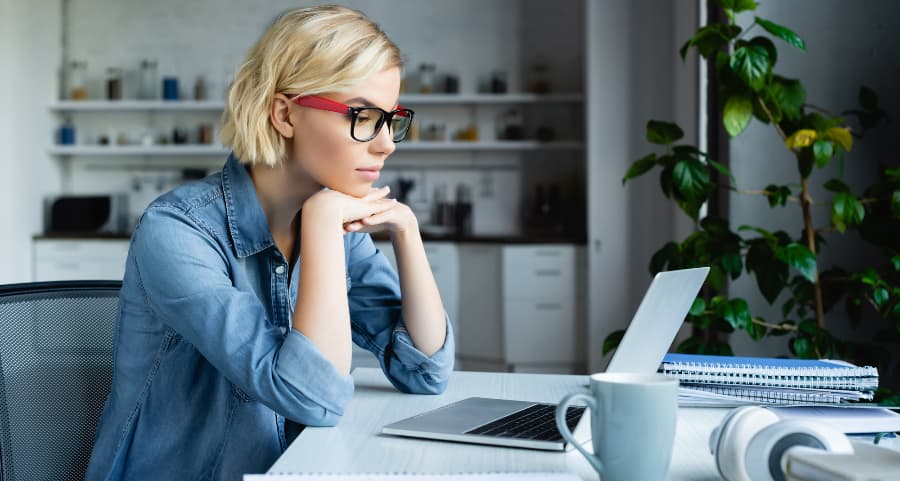 Individual using laptop in home office